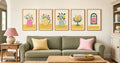 Five printable cottage art prints displayed above a sage green sofa
